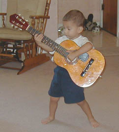 He holds the guitar really well especially for a 2 year old!
